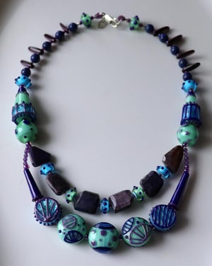 Lapis River - junk drawer necklace featuring loads of lampwork and sugilite