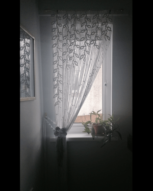 Long macramé curtain with macramé flower tie