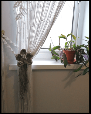 Long macramé curtain with macramé flower tie