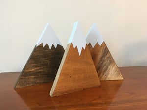 Image of Wood snow capped mountain displays