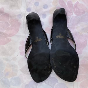 Little black flip flop kitten heels with a flower detail on the strap