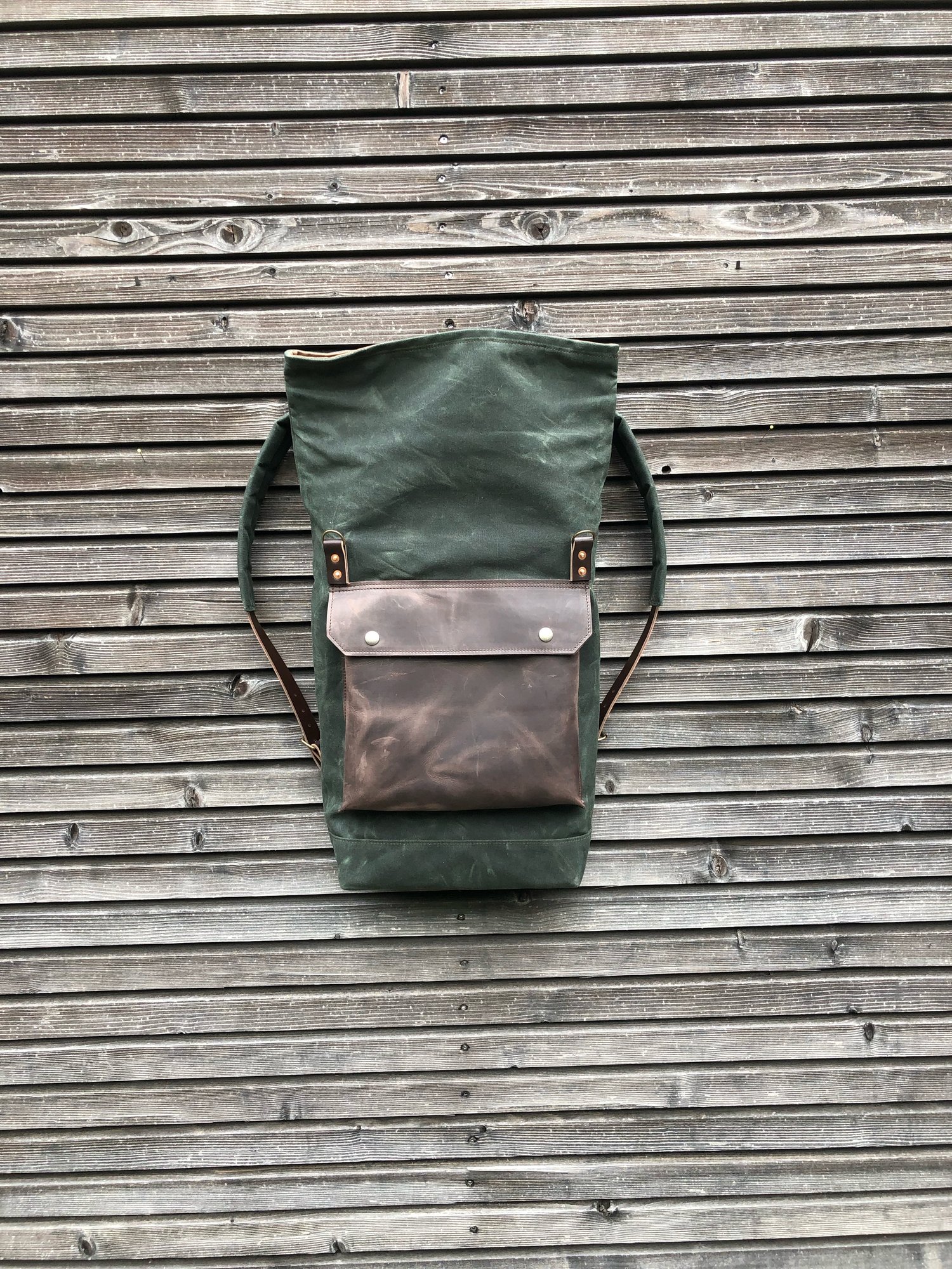 Image of Backpack in waxed canvas with waxed leather front pocket and roll to close top