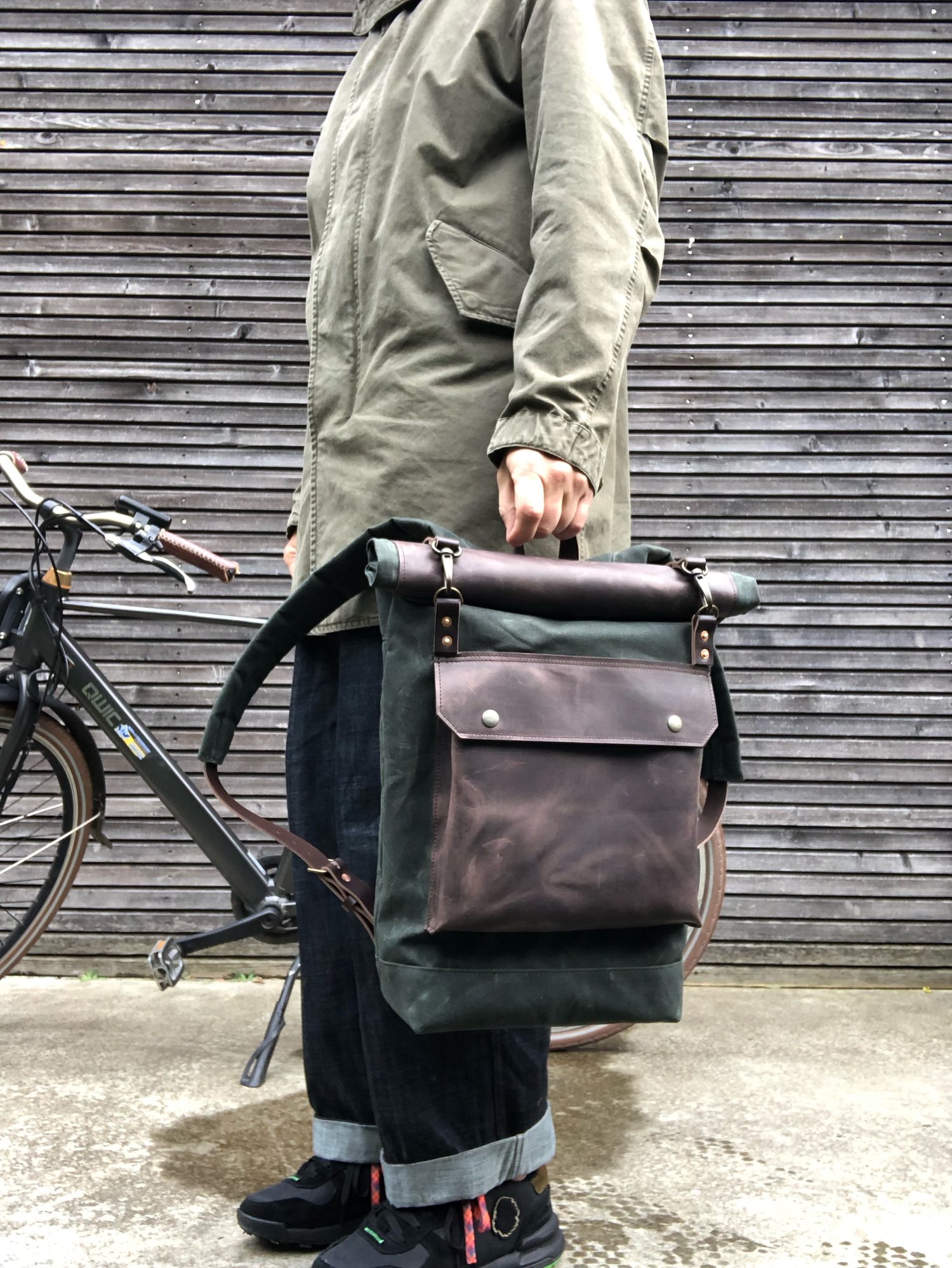 Image of Backpack in waxed canvas with waxed leather front pocket and roll to close top