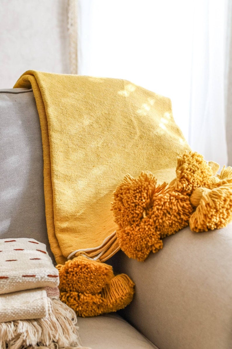 Image of MOROCCAN POMPOM BLANKET - MUSTARD