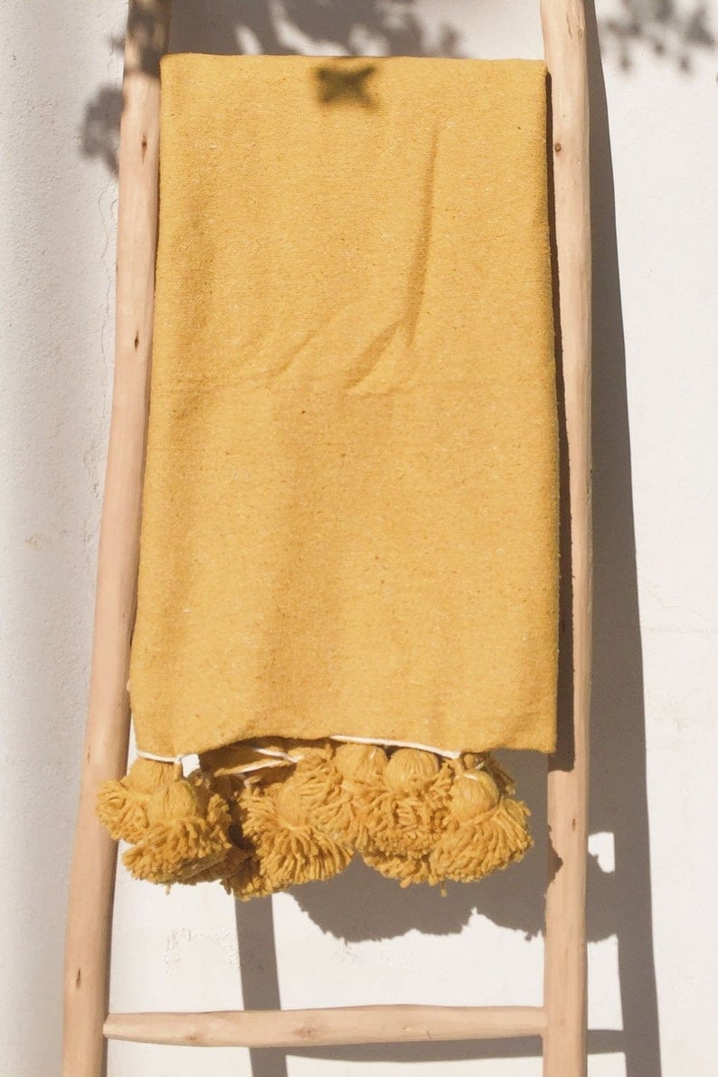 Image of MOROCCAN POMPOM BLANKET - MUSTARD