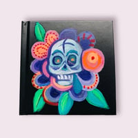 Black sketchbook with skull flower