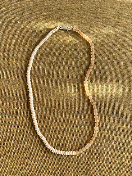 WHISPERING YOU EVERLASTING SUMMER SECRETS

Dune sand beaded necklace is treaded with graduated mineral stones, half strand of round matte Quartz beads and other half with white Turquoise disks.
Length is 42,5 cm but please send us an email if you wish a different length.

We love it on its own, or resting amongst your everyday gold favorites.

This piece is created in limited numbers.