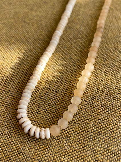 WHISPERING YOU EVERLASTING SUMMER SECRETS

Dune sand beaded necklace is treaded with graduated mineral stones, half strand of round matte Quartz beads and other half with white Turquoise disks.

We love it on its own, or resting amongst your everyday gold favorites.

This piece is created in limited numbers.