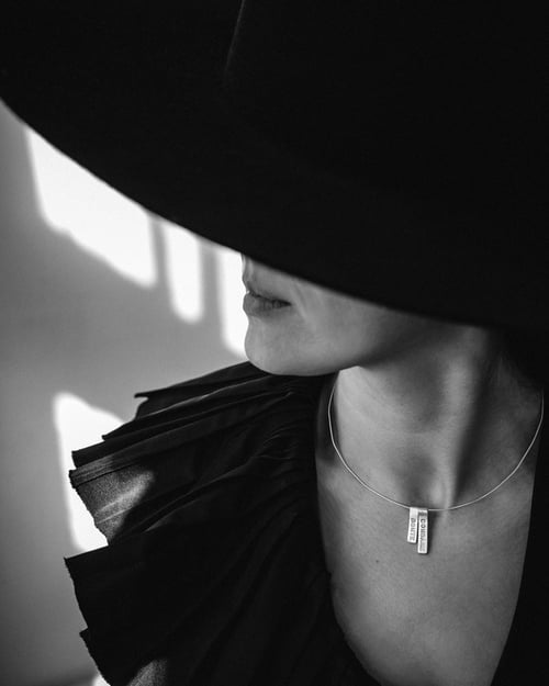 Image of silver pendant with inscription in Latin