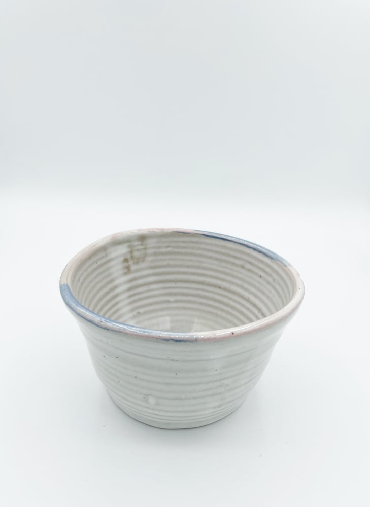 Image of White Bowl with pink and blue rim 