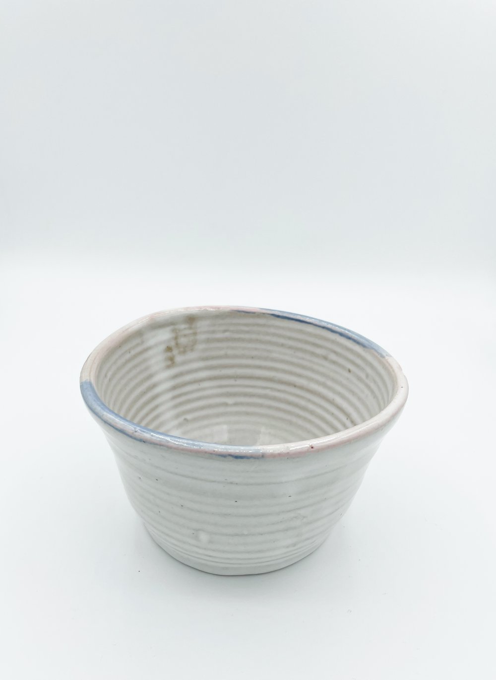 Image of White Bowl with pink and blue rim 
