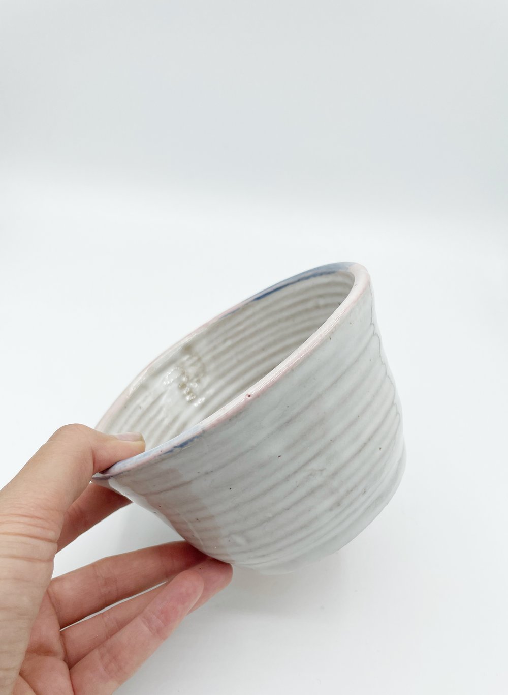 Image of White Bowl with pink and blue rim 