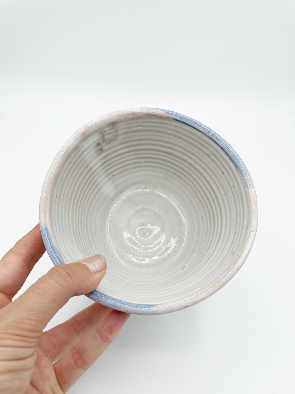 Image of White Bowl with pink and blue rim 