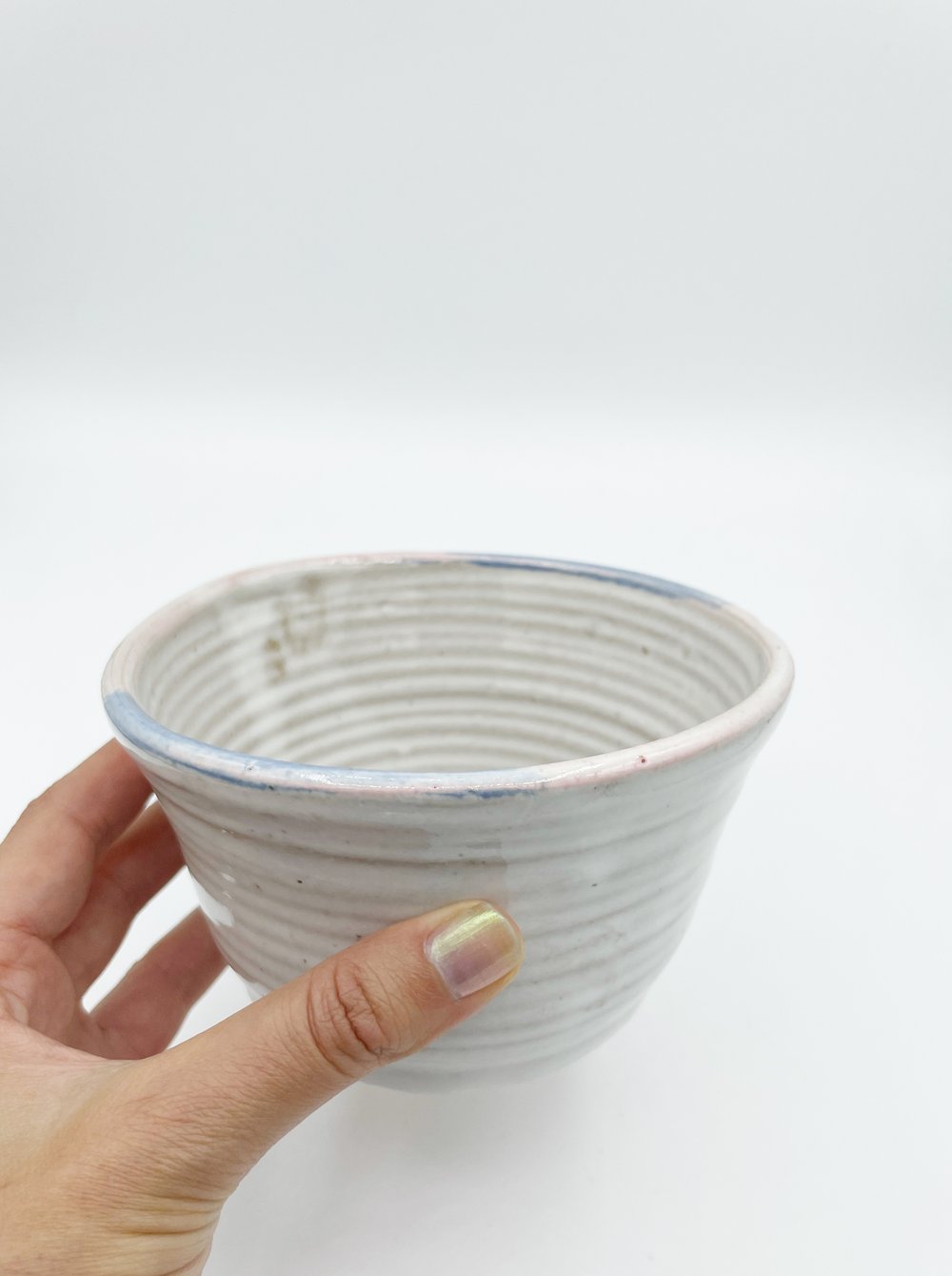 Image of White Bowl with pink and blue rim 