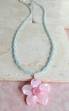 Carved Pink Mother of Pearl Shell Pendant on a Necklace of Small Pale Blue Rice Beads