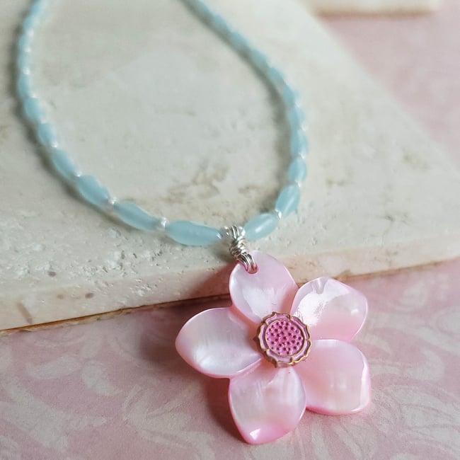 Carved Pink Mother of Pearl Shell Pendant on a Necklace of Small Pale Blue Rice Beads