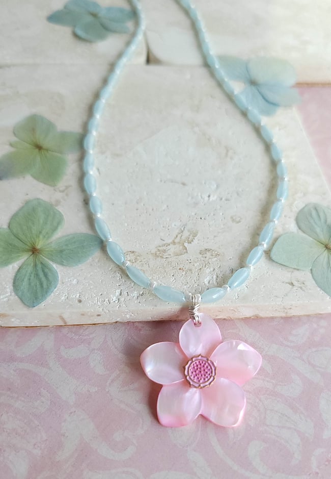 Carved Pink Mother of Pearl Shell Pendant on a Necklace of Small Pale Blue Rice Beads