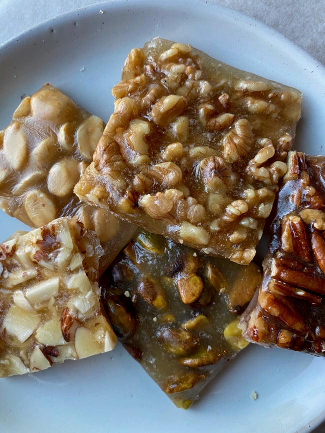 Mixed nut brittle in a tin