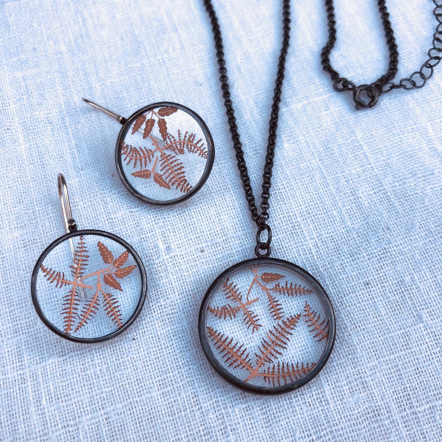 Image of Copper fern botanicals under glass