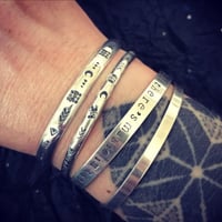Image 3 of 'Luna' symbol stamped cuff bracelet. Slim silver Aztec patterned cuff bracelet. 