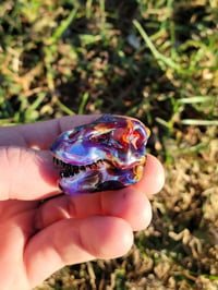 Image 1 of Amber purple Tyrannosaurus rex skull pendant.