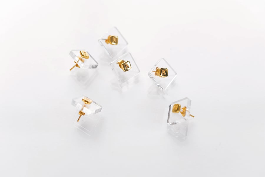 Image of gold plated silver earring with letter