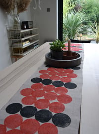 Linen table runner with a circles print in black & orange