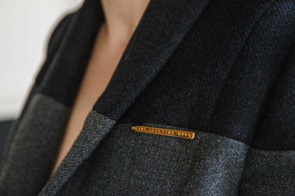 Image of gold plated silver brooch with inscription in Latin