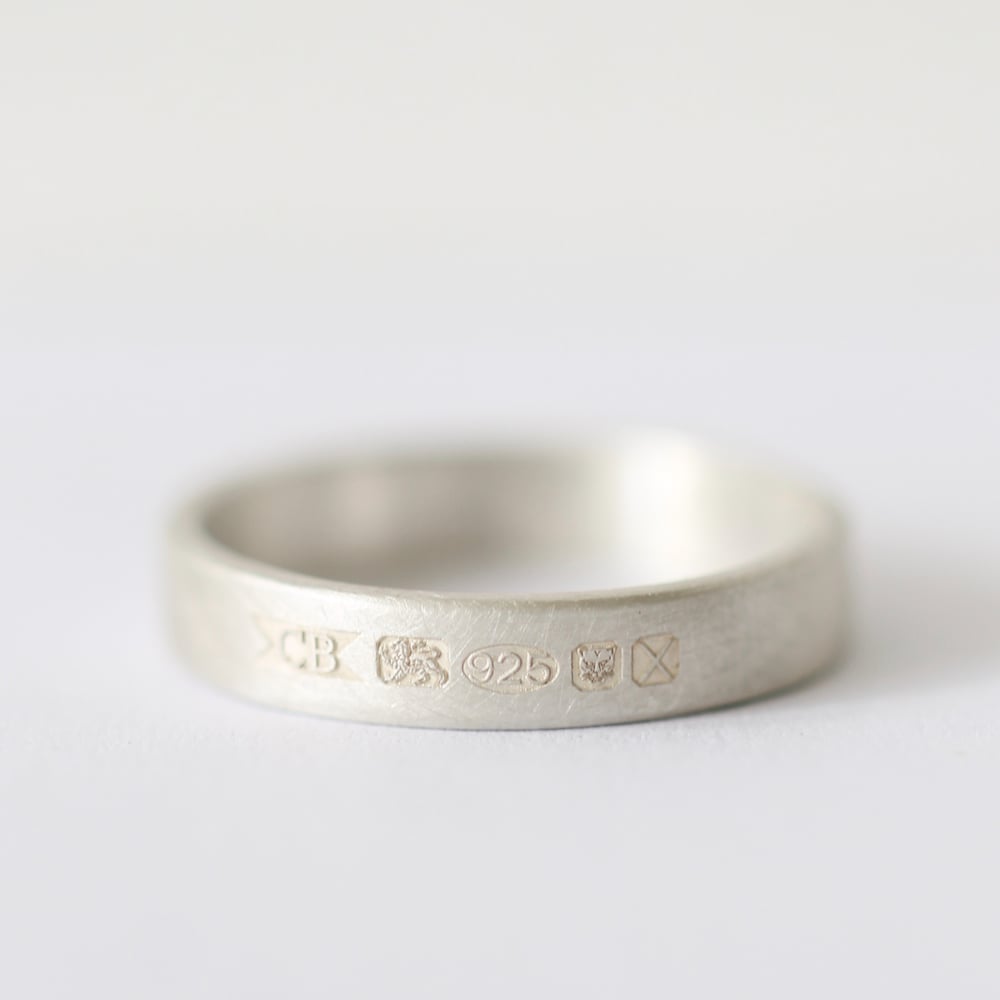 Image of Flat band ring with feature hallmark