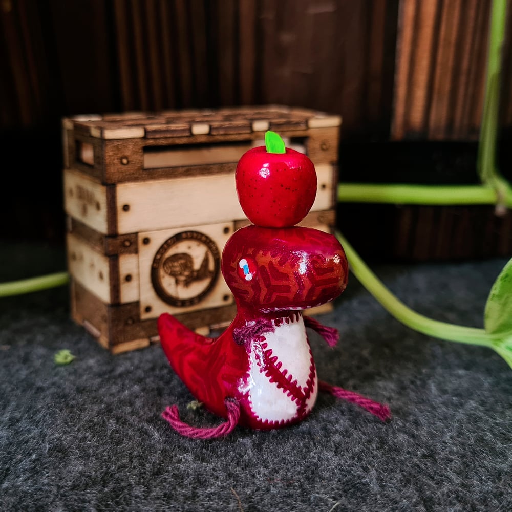 Handmade Dinoboi figure with stuffed shipping crate and glittery apple