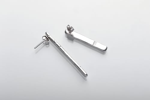 Image of long plain silver earrings with inscription in Latin