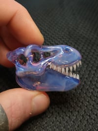 Image 2 of Opalescent cfl reactive Tyrannosaurus rex skull pendant.