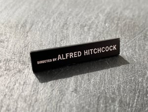 "Directed by Alfred Hitchcock" soft enamel pin