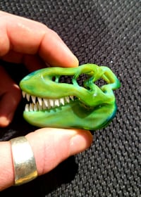 Image 1 of Green energy Tyrannosaurus Rex skull pendant. 