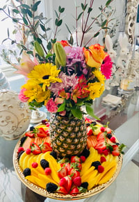 Cored Pineapple with Fresh Flowers amidst Fresh Hand Carved Fruit