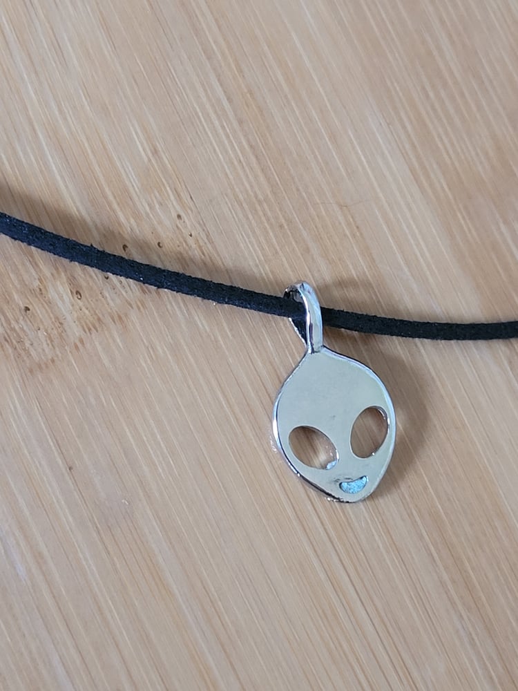 Image of silver colored alien necklace