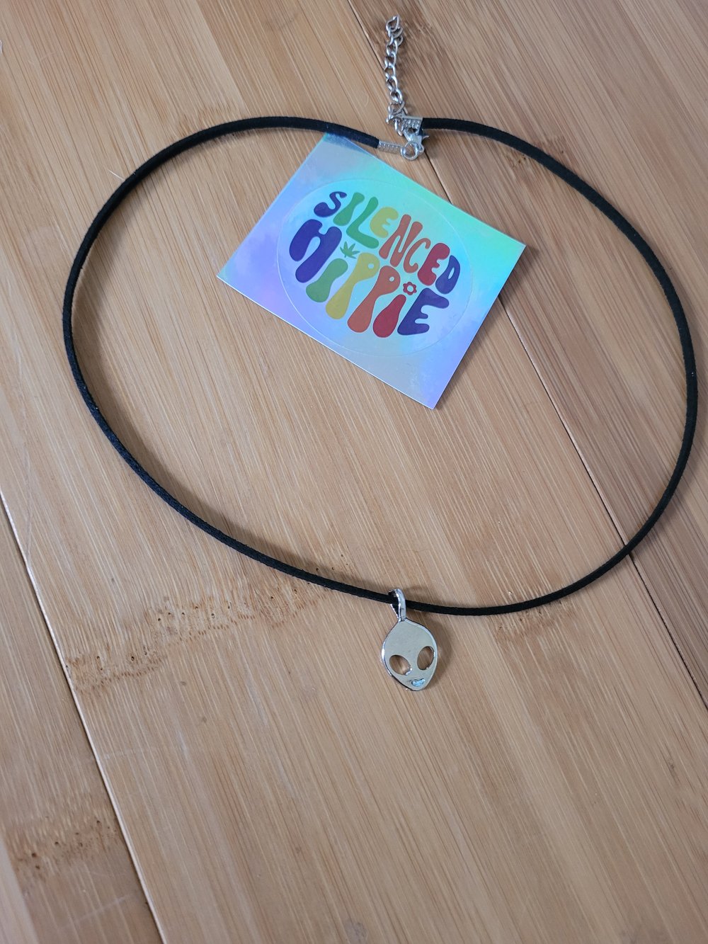 Image of silver colored alien necklace
