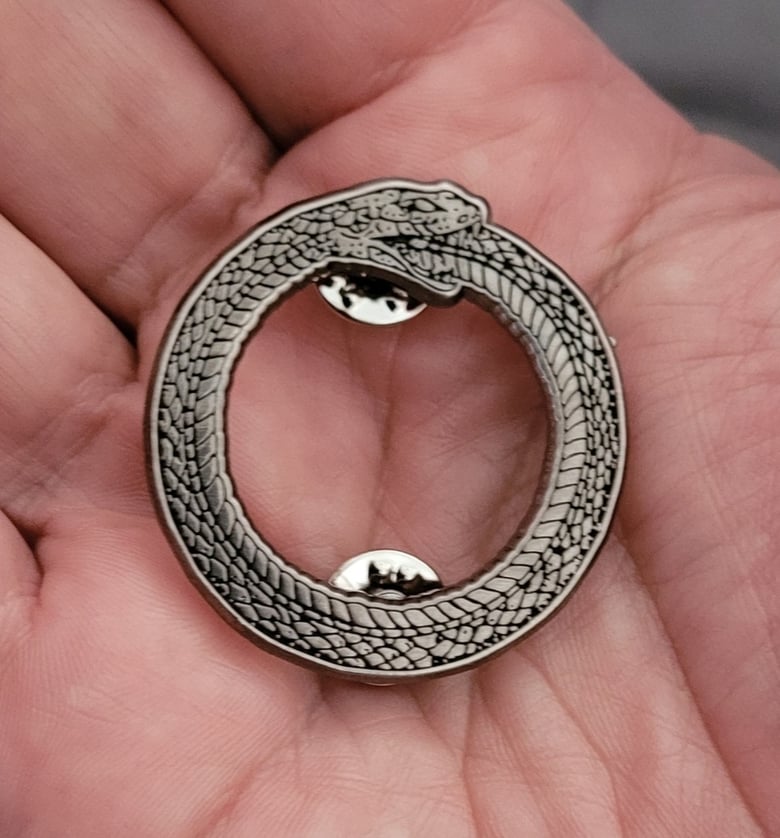 Image of Ouroboros circular enamel pin third pressing  