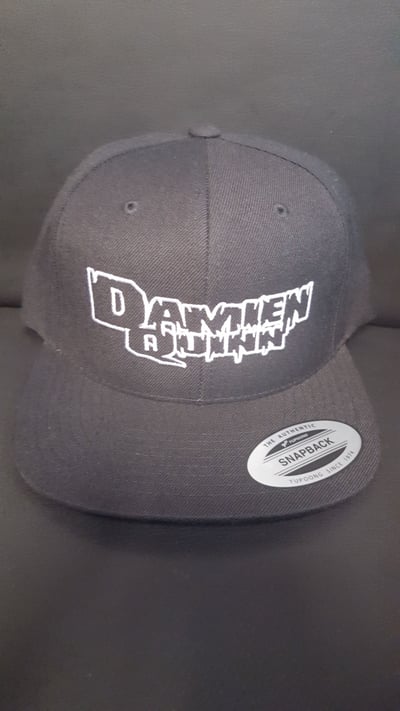 Image of DAMIEN QUINN : BLACK HAT WITH BLACK LOGO WITH WHITE OUTLINE