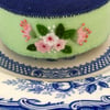 green and pink teacup pincushion