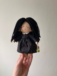 Image 1 of Wednesday Addams doll.