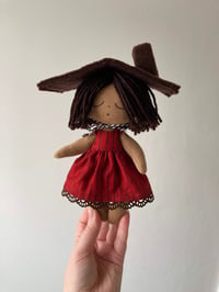 Image 1 of Red cabin doll.