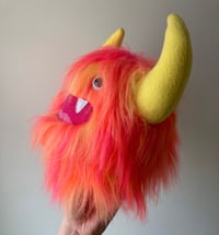 Image 2 of medium pink, orange and yellow horned monster plushie