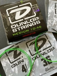 Image 1 of Dunlop Neon Green Monster Energy Plain Steel Electric Guitar Strings Med. 10-46