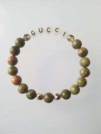 Image 1 of Glow in the dark word GUCCI 