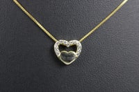 Gold heart charm necklace.