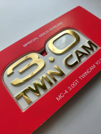 Image 2 of 3.0 Twin Cam Metal Emblem (Gold/White)