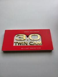 Image 1 of 3.0 Twin Cam Metal Emblem (Gold/White)