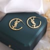 YSL gold earrings.