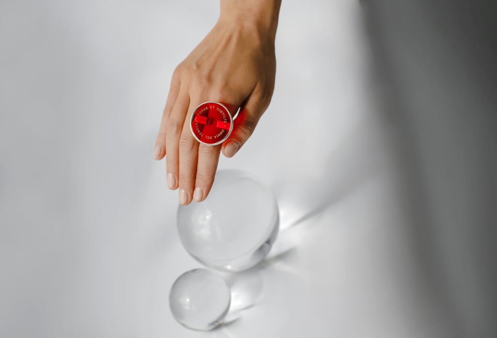 Image of "The sun warms everything.." silver ring with red plexiglass · OMNIA SOL TEMPERAT · 